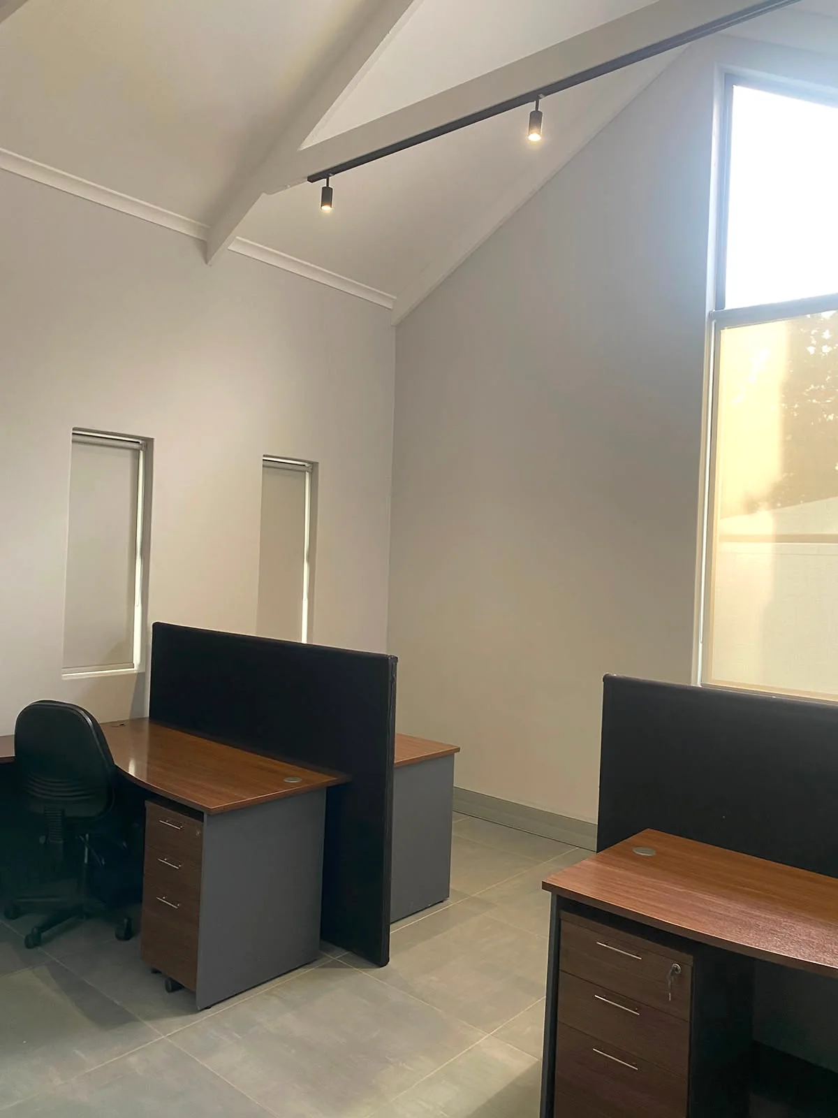 Partitioned desks and an office chair in the shared workspace at 17 Private Road