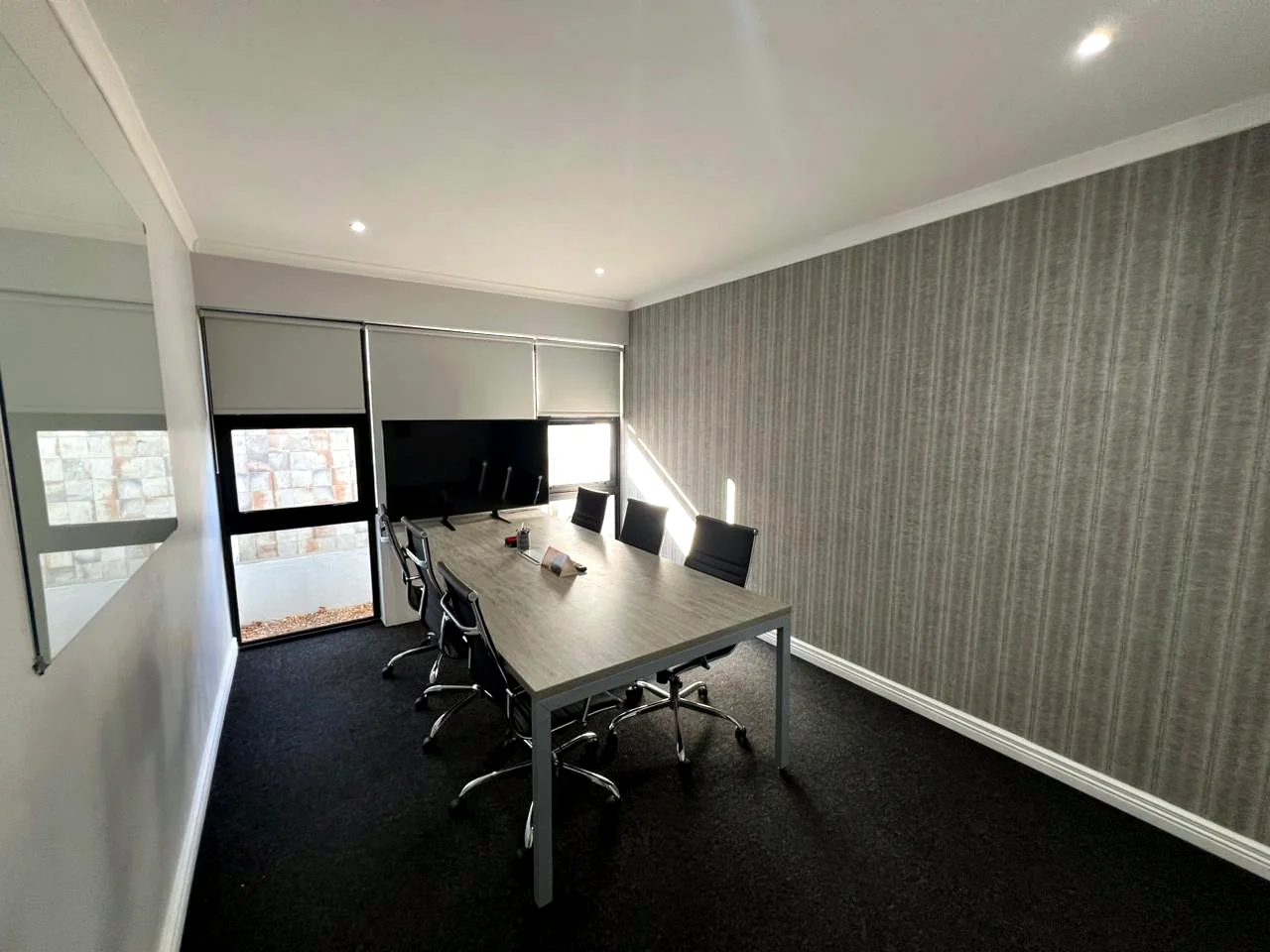 Private Street boardroom with meeting table and screen
