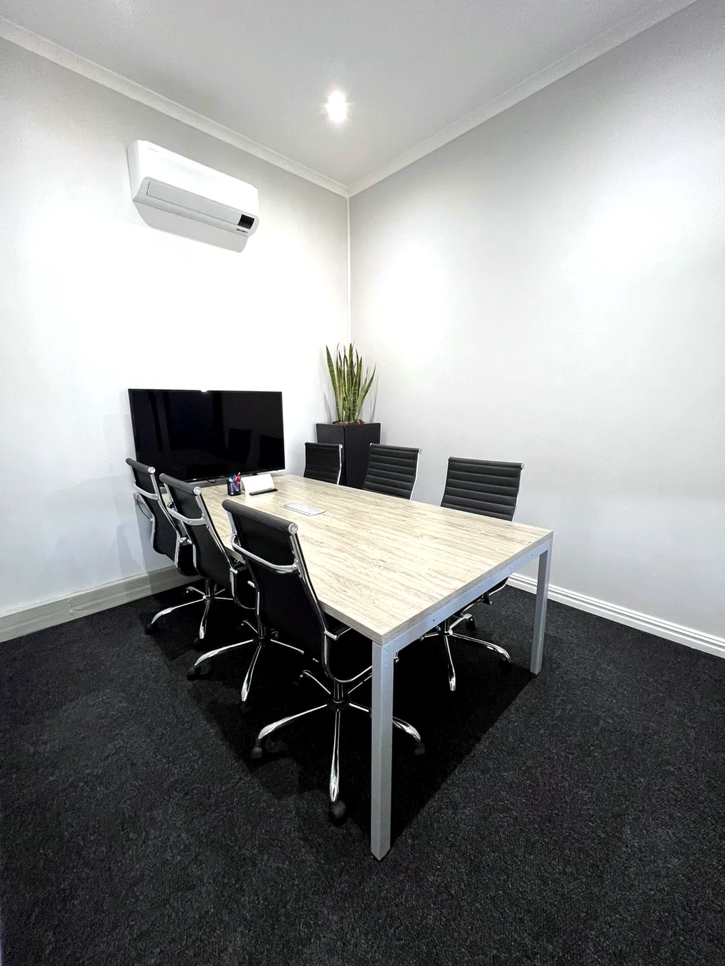 Private Street compact boardroom with screen, table and chairs
